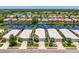 Scenic aerial view of the neighborhood homes, situated on canals, and backing up to a golf course at 8731 52Nd E Dr, Bradenton, FL 34211