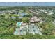 Expansive aerial view showcasing the community's golf course, tennis courts, pool, and beautiful landscaping at 8731 52Nd E Dr, Bradenton, FL 34211
