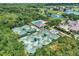 Aerial view of tennis courts, a pool, and golf course, all set in a lush, green environment at 8731 52Nd E Dr, Bradenton, FL 34211