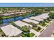 Aerial view of homes along a serene canal, with beautifully maintained lawns and verdant greenery at 8731 52Nd E Dr, Bradenton, FL 34211