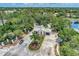 Aerial view of the community entrance with guard house, lush landscaping, and water features at 8731 52Nd E Dr, Bradenton, FL 34211