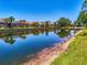 Picturesque backyard view of a waterfront property featuring lush landscaping and tranquil water reflections at 8731 52Nd E Dr, Bradenton, FL 34211