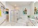 Bright bathroom features a garden tub, tiled shower, and vanity with granite counters at 8731 52Nd E Dr, Bradenton, FL 34211