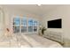 Comfortable bedroom featuring a large window, ceiling fan, and neutral decor at 8731 52Nd E Dr, Bradenton, FL 34211