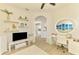 Bedroom featuring vanity, decorative display shelves, and an arched doorway at 8731 52Nd E Dr, Bradenton, FL 34211