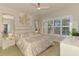 Airy bedroom showcasing bright natural light, a ceiling fan, and decorative accents at 8731 52Nd E Dr, Bradenton, FL 34211