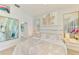 Comfortable bedroom with an accent wall, ceiling fan, and decorative mirror at 8731 52Nd E Dr, Bradenton, FL 34211
