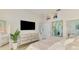 Spacious bedroom with a mounted TV, and an ensuite bath at 8731 52Nd E Dr, Bradenton, FL 34211