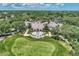 Aerial view of the gorgeous clubhouse with outdoor seating and lush landscaping on the golf course at 8731 52Nd E Dr, Bradenton, FL 34211