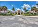 Beautiful clubhouse exterior featuring palm trees and manicured landscaping on a sunny day at 8731 52Nd E Dr, Bradenton, FL 34211