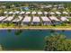 Aerial view of the residential community featuring waterfront properties with screened-in pools and mature landscaping at 8731 52Nd E Dr, Bradenton, FL 34211