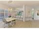 Dining area with modern chandelier, bar seating, and sightlines to the living area at 8731 52Nd E Dr, Bradenton, FL 34211