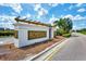 Rosedale entrance sign with a pergola, beautiful gold lettering, and mature landscaping at 8731 52Nd E Dr, Bradenton, FL 34211