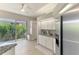 Bright kitchen featuring granite countertops, white cabinets, and a slider to a private courtyard at 8731 52Nd E Dr, Bradenton, FL 34211