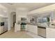 Open kitchen featuring stainless steel appliances, granite counters, and bar-style seating at 8731 52Nd E Dr, Bradenton, FL 34211