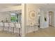 Kitchen with breakfast bar featuring granite countertops and white stools at 8731 52Nd E Dr, Bradenton, FL 34211
