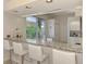 Kitchen bar with granite countertop, white cabinetry, and garden view at 8731 52Nd E Dr, Bradenton, FL 34211