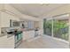 Well-lit kitchen with stainless steel appliances, granite counters, and a view to the living room at 8731 52Nd E Dr, Bradenton, FL 34211