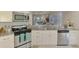 Bright kitchen with stainless steel appliances, granite counters and view of the living room at 8731 52Nd E Dr, Bradenton, FL 34211
