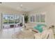 Cozy living room featuring a white sectional sofa and access to the pool area at 8731 52Nd E Dr, Bradenton, FL 34211