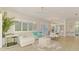 Open-concept living space with stylish furnishings, abundant natural light, and light wood floors at 8731 52Nd E Dr, Bradenton, FL 34211
