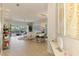 Open concept living space with dining area, modern decor, and sliding glass doors to the outdoor pool at 8731 52Nd E Dr, Bradenton, FL 34211