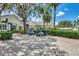 Parking area with golf carts and landscaping, showcasing the exterior of the clubhouse at 8731 52Nd E Dr, Bradenton, FL 34211