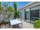 Outdoor patio space with a table and chairs and well manicured landscaping at 8731 52Nd E Dr, Bradenton, FL 34211