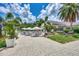 Scenic patio with ample seating, umbrellas, manicured landscaping, and views of the golf course at 8731 52Nd E Dr, Bradenton, FL 34211