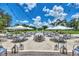 Outdoor patio featuring ample seating, umbrellas, and string lights with golf course views at 8731 52Nd E Dr, Bradenton, FL 34211