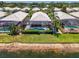 Aerial view of the pool and lanai area, complemented by well-manicured landscaping and waterfront view at 8731 52Nd E Dr, Bradenton, FL 34211