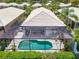 Aerial view of the backyard pool with a screened enclosure and patio furniture at 8731 52Nd E Dr, Bradenton, FL 34211