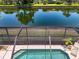 View of the pool and screened-in lanai area, with a view of the lush backyard and waterfront at 8731 52Nd E Dr, Bradenton, FL 34211