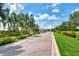 Street view of the lush green entryway into the neighborhood with manicured lawns and foliage at 8731 52Nd E Dr, Bradenton, FL 34211