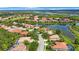 Wonderful aerial view of a home on 9635 Discovery Terrace featuring a lake view and manicured landscaping at 9635 Discovery Ter, Bradenton, FL 34212