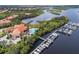 Aerial view showcasing waterfront living with a community pool, boat docks, and lush landscaping at 9635 Discovery Ter, Bradenton, FL 34212