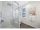 Bright bathroom with herringbone floors and glass enclosed shower at 9635 Discovery Ter, Bradenton, FL 34212