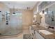 Modern bathroom with a frameless glass shower, double sink vanity, and neutral-toned walls at 9635 Discovery Ter, Bradenton, FL 34212