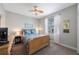 Comfortable bedroom with a wood-frame bed, ceiling fan, and plenty of natural light at 9635 Discovery Ter, Bradenton, FL 34212