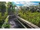 Picturesque wooded boardwalk winding through a tropical community at 9635 Discovery Ter, Bradenton, FL 34212