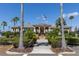View of the Waterlefe Golf & River Club clubhouse with manicured landscaping and palm trees at 9635 Discovery Ter, Bradenton, FL 34212