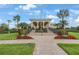 View of the Waterlefe Golf & River Club clubhouse entrance with manicured landscaping and an American flag at 9635 Discovery Ter, Bradenton, FL 34212