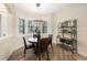 Inviting dining room area with plenty of natural light, wood floors, and a metal shelf for display at 9635 Discovery Ter, Bradenton, FL 34212