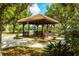 Community gazebo with seating surrounded by trees and a waterway in the background at 9635 Discovery Ter, Bradenton, FL 34212