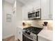 Modern kitchen featuring stainless steel appliances, white cabinetry, and light countertops with a gas range at 9635 Discovery Ter, Bradenton, FL 34212