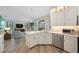 Stylish kitchen featuring stainless steel appliances, light countertops, and an open layout to the adjacent living area at 9635 Discovery Ter, Bradenton, FL 34212