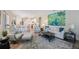 Bright, open living room featuring a modern rug, comfortable seating, and an open floor plan to the kitchen at 9635 Discovery Ter, Bradenton, FL 34212