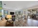 Bright and airy living room with wood-look floors, large windows, and sliding glass doors leading to an outdoor space at 9635 Discovery Ter, Bradenton, FL 34212