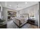 Tranquil main bedroom with a sliding glass door to outdoor lanai and backyard at 9635 Discovery Ter, Bradenton, FL 34212