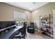 Brightly lit home office with dark desk and comfortable seating at 9635 Discovery Ter, Bradenton, FL 34212
